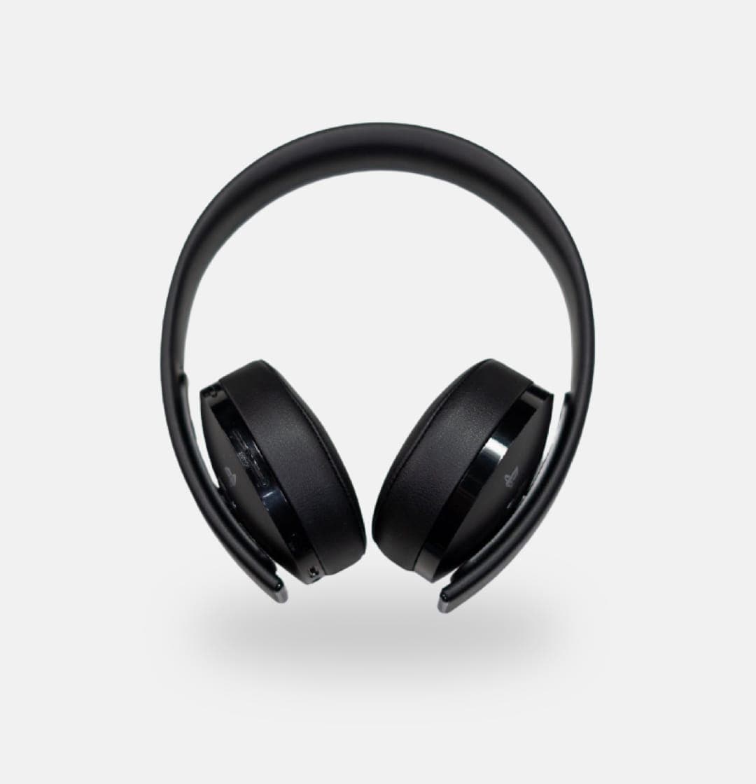 Black over-ear headphones resting on a white background. The headphones have a thick headband that curves down to meet the earcups. The earcups are plush and well-padded.