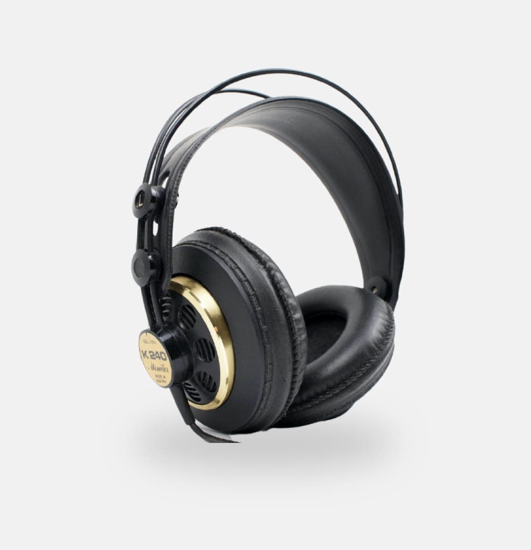 Black over-ear studio headphones with gold accents, folded and resting on a clean white background.